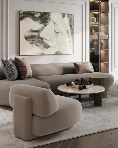 Скандинавський коричневий диван Коричневий диван у скандинавському інтер'єрі з білими стінами, дерев'яною підлогою та пледом.