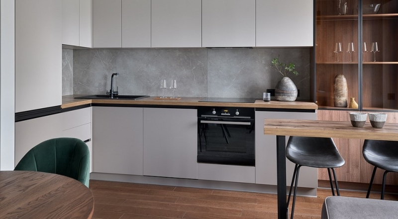 Кухонна дерев'яна стільниця Дерев'яна стільниця в інтер'єрі кухні з натурального дерева та світлими шафами.